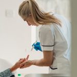 Diabetolog mierzy poziom cukru pacjenta