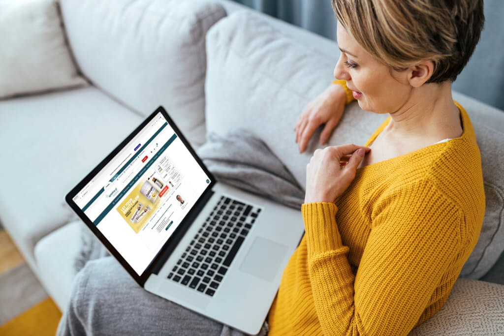 Woman using laptop and having video call with her doctor while sitting at home.