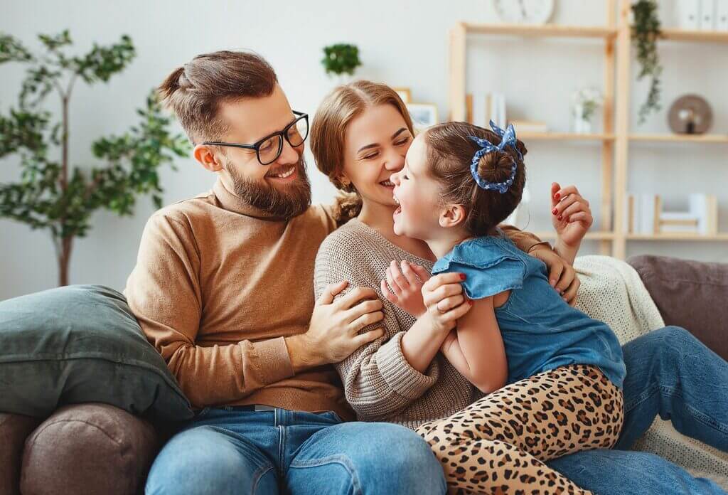 happy family mother father and child daughter laughing at home